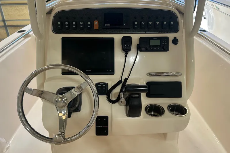 Slide: The Image of 2021 Grady-White Fisherman 216 console with steering wheel, controls, and navigation equipment. - 4