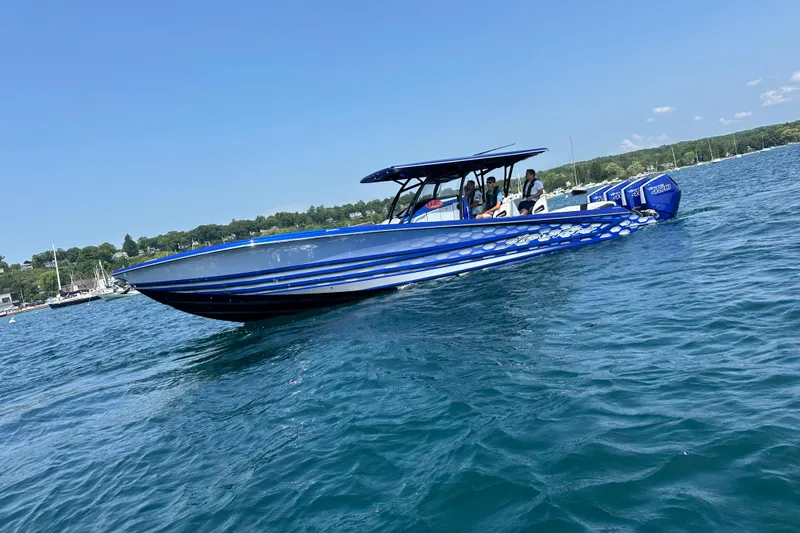 Slide: The Image of 2025 Nor-Tech 390 Sport boat cruising on clear blue water under a sunny sky. - 11