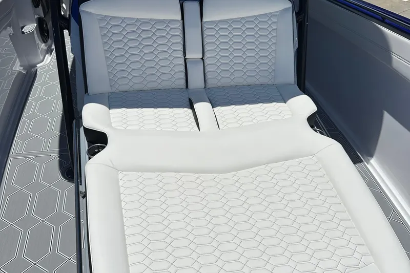 Slide: The Image of 2025 Nor-Tech 390 Sport boat interior with white hexagonal-patterned seating and flooring. - 18