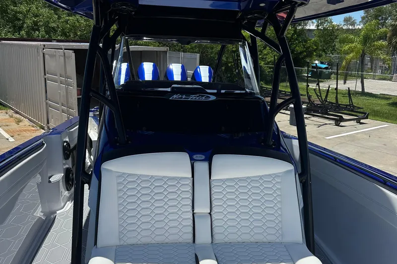 Slide: The Image of 2025 Nor-Tech 390 Sport boat interior with white seating and blue accents. - 19