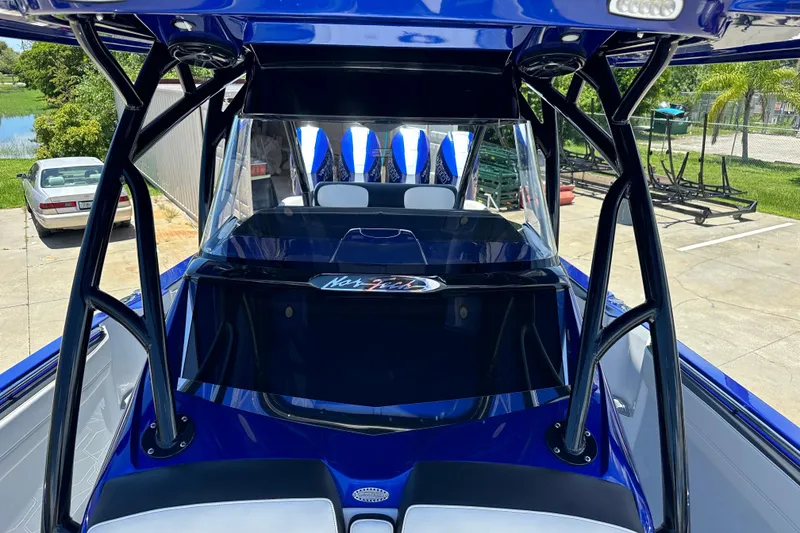 Slide: The Image of 2025 Nor-Tech 390 Sport boat, blue exterior, sleek design, parked outdoors. - 21