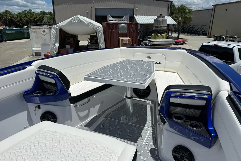 Slide: The Image of 2025 Nor-Tech 390 Sport boat interior with sleek seating and modern table design. - 22