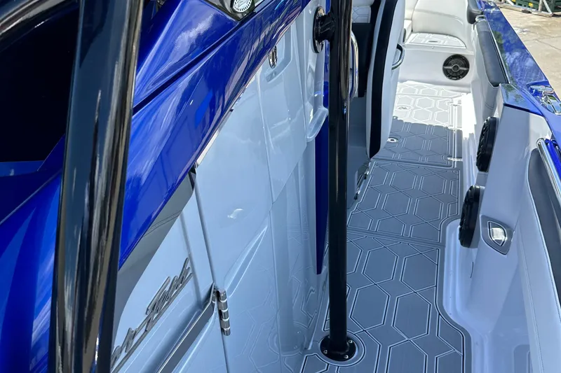 Slide: The Image of 2025 Nor-Tech 390 Sport boat interior with sleek blue and white design. - 24