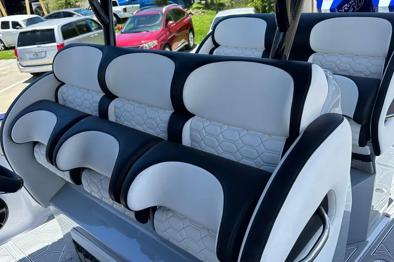Slide: The Image of Luxury seating on 2025 Nor-Tech 390 Sport boat, featuring black and white upholstery. - 25