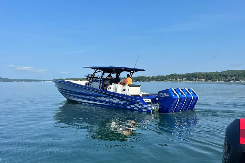 Slide: The Image of 2025 Nor-Tech 390 Sport boat with quad engines on a calm lake. - 8