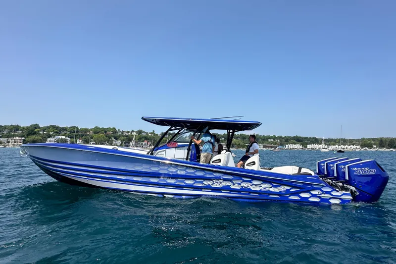 Slide: The Image of 2025 Nor-Tech 390 Sport boat on water, featuring blue design and powerful engines. - 9