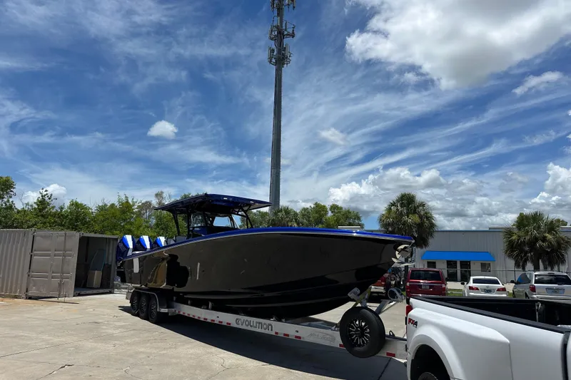 Slide: The Image of 2025 Nor-Tech 390 Sport boat on trailer under a clear blue sky. - 15