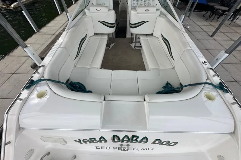 Slide: The Image of 1999 Envision 3200 Intruder boat with white seating and green accents, docked at Des Peres, MO. - 13