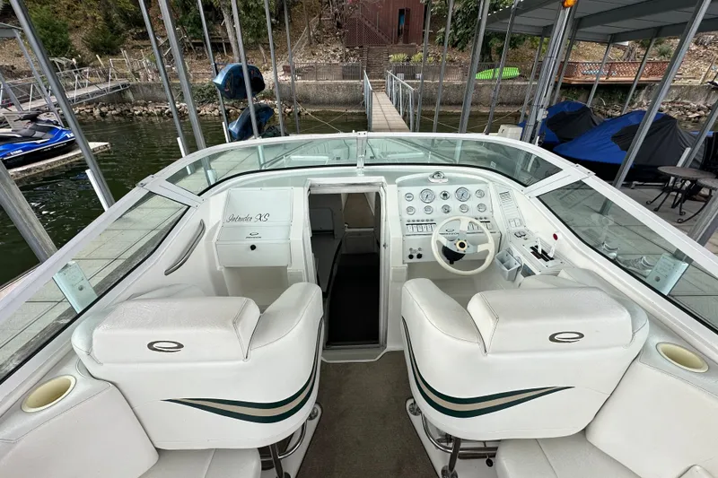 Slide: The Image of 1999 Envision 3200 Intruder boat interior with white seating and control panel. - 14