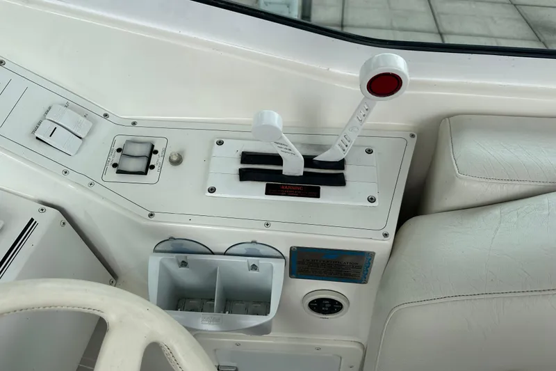 Slide: The Image of Control panel of a 1999 Envision 3200 Intruder boat with throttle levers. - 16