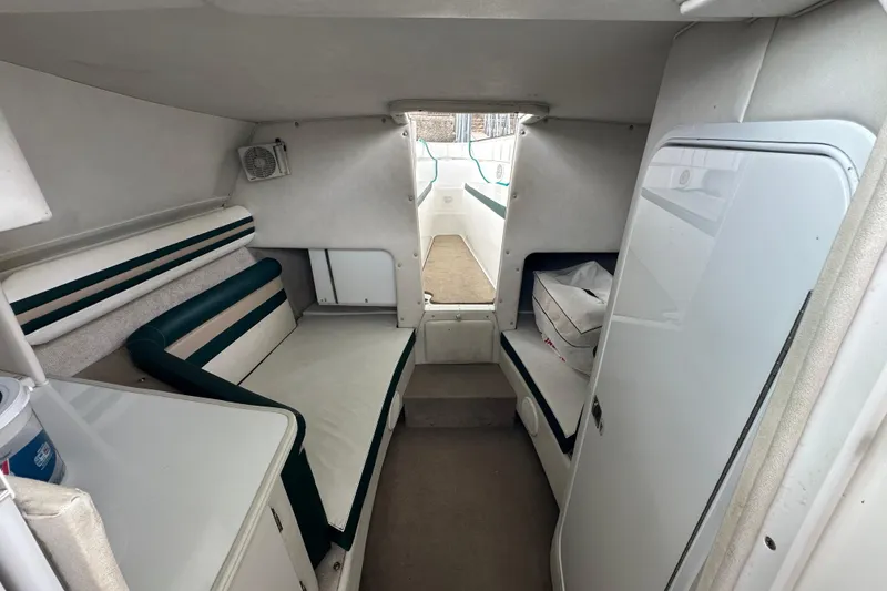 Slide: The Image of Interior of 1999 Envision 3200 Intruder boat, featuring seating and storage areas. - 17