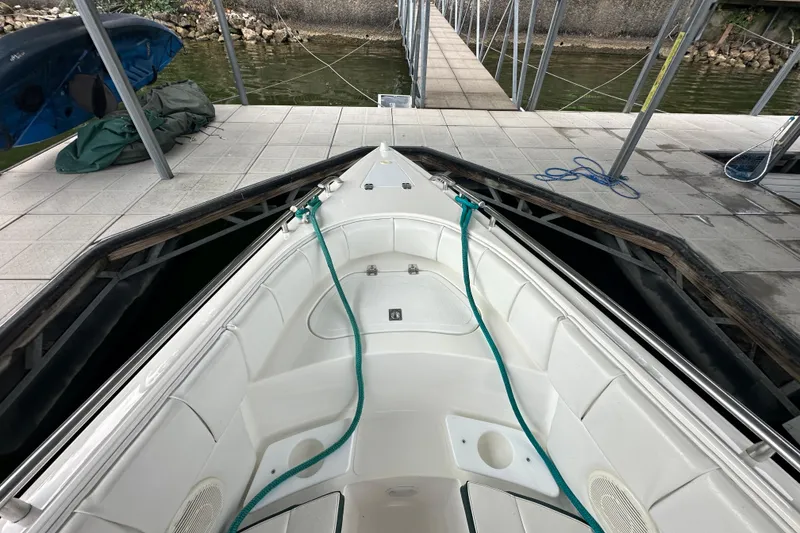 Slide: The Image of 1999 Envision 3200 Intruder boat docked, showing bow seating and mooring lines. - 23