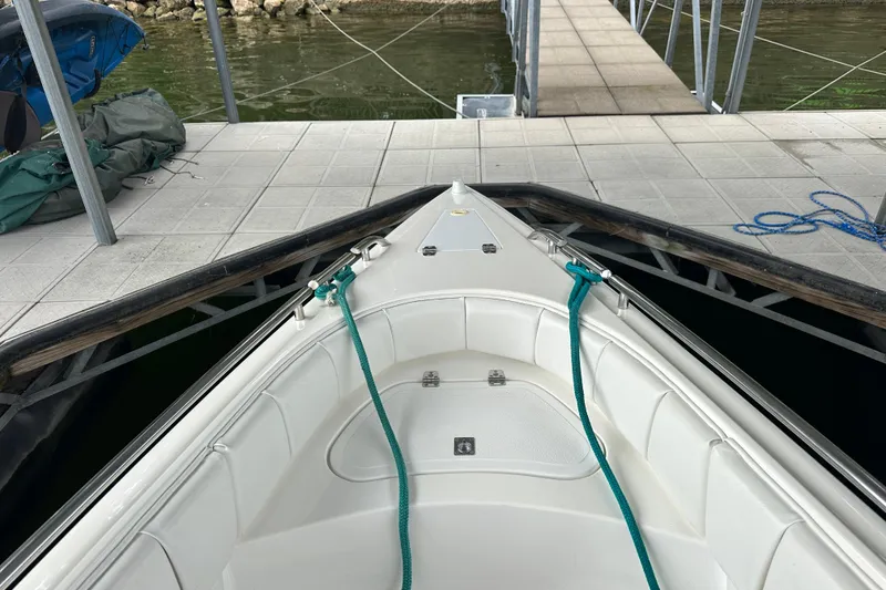Slide: The Image of Bow of 1999 Envision 3200 Intruder boat docked at marina. - 25