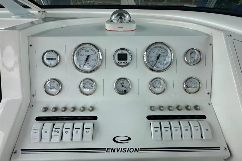 Slide: The Image of Control panel of a 1999 Envision 3200 Intruder boat with gauges and switches. - 27