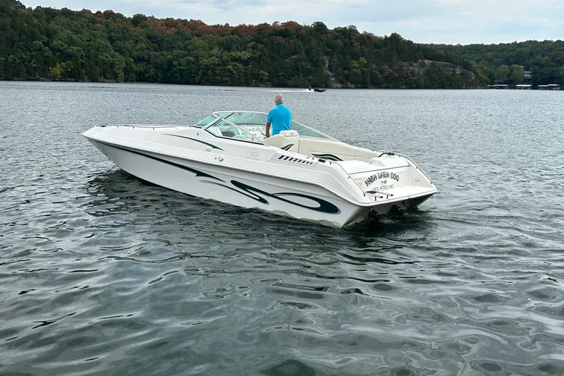 Slide: The Image of 1999 Envision 3200 Intruder boat on a lake with scenic forest backdrop. - 5