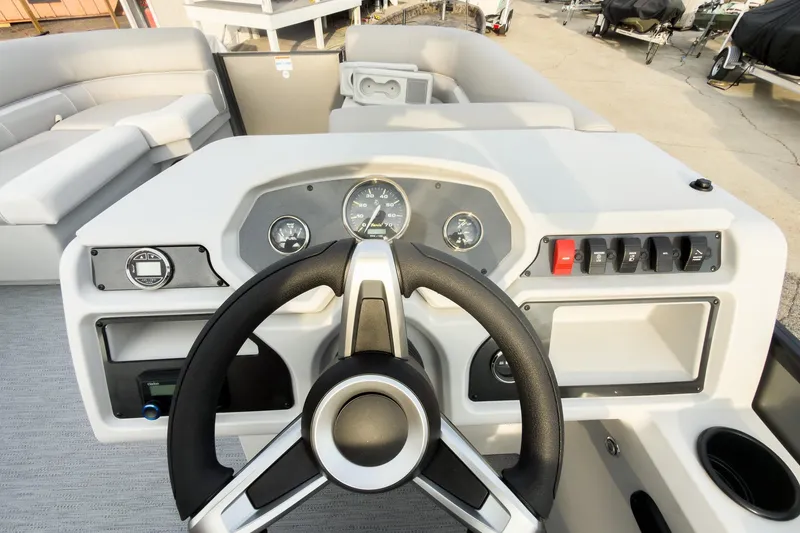 Slide: The Image of Steering console of 2026 Godfrey Sweetwater Xperience 22' Tritoon, featuring modern controls and gauges. - 17