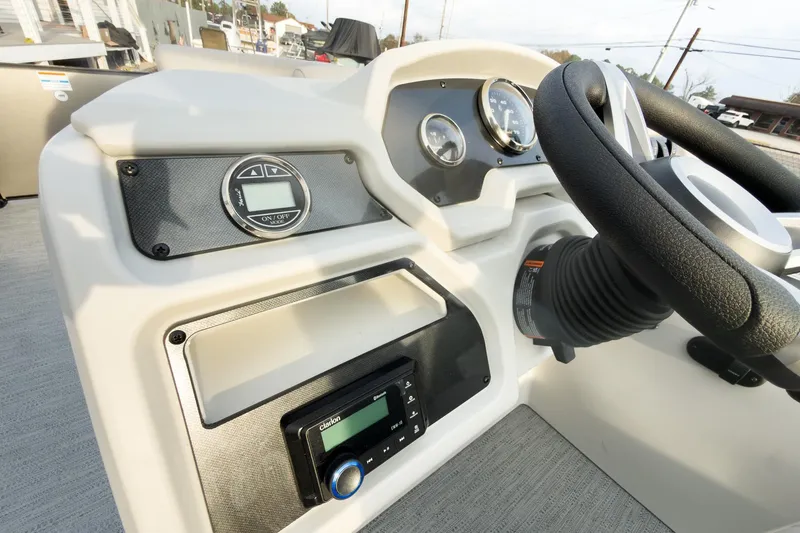 Slide: The Image of 2026 Godfrey Sweetwater Xperience 22' Tritoon dashboard with steering wheel and control panel. - 18