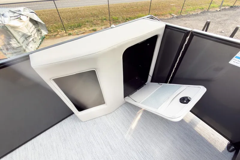 Slide: The Image of 2026 Godfrey Sweetwater Xperience 22' Tritoon storage compartment with open hatch and sleek design. - 23