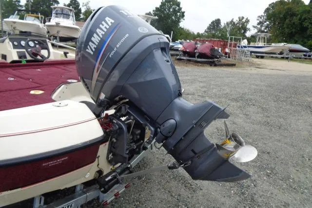 Slide: The Image of 1996 Quantum 180 XD boat with Yamaha outboard motor in a marina setting. - 14