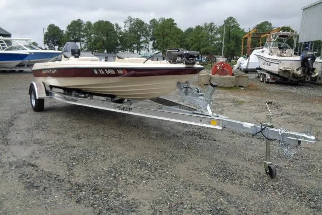 Slide: The Image of 1996 Quantum 180 XD boat on trailer in outdoor storage area. - 2