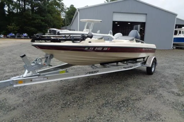 Slide: The Image of 1996 Quantum 180 XD boat on trailer, parked outside a large garage. - 4