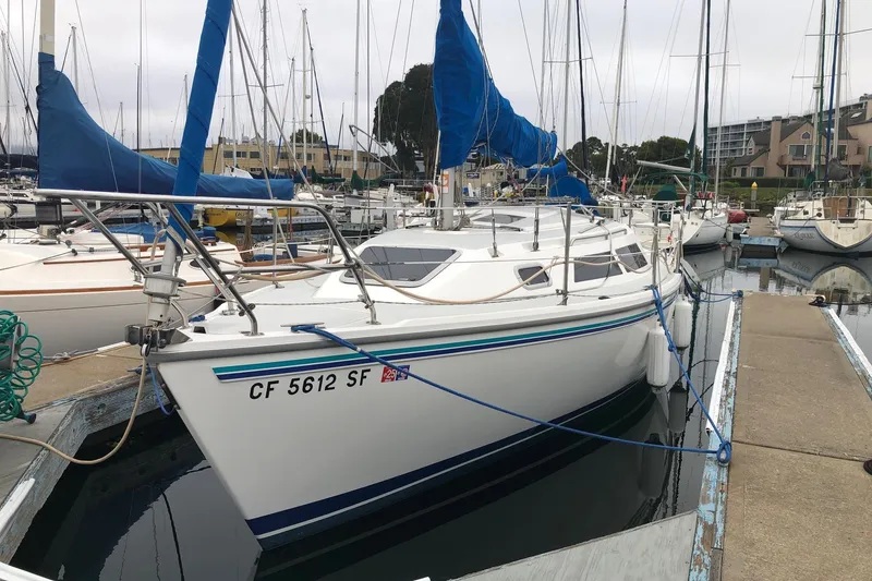 The Image of 1995 Catalina 270 sailboat docked in marina with blue sail covers. - 0