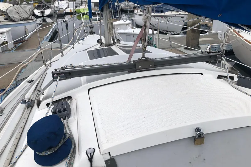 Slide: The Image of Sailboat deck view of 1995 Catalina 270, docked with visible rigging and blue cover. - 14