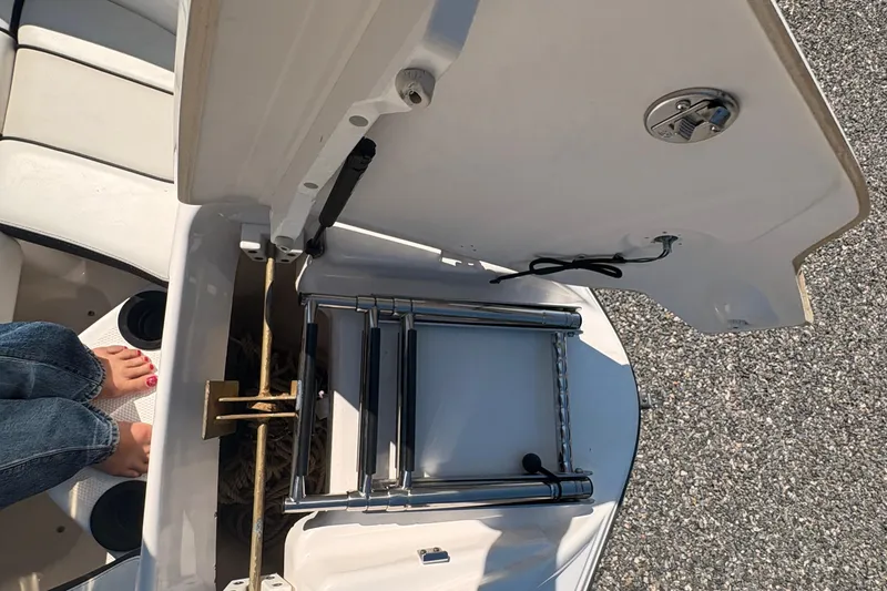 Slide: The Image of Open hatch of 2018 Yamaha SX210 boat showing ladder and storage compartment. - 15