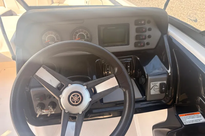 Slide: The Image of 2018 Yamaha SX210 boat dashboard with steering wheel and control panel. - 19