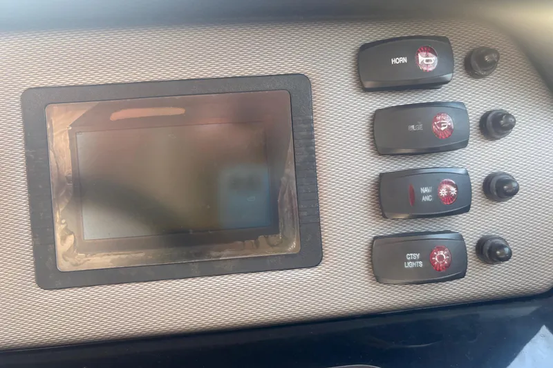 Slide: The Image of Dashboard controls of a 2018 Yamaha Boats SX210, featuring switches and a display screen. - 20