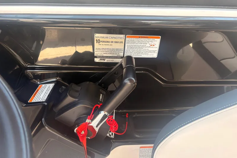 Slide: The Image of 2018 Yamaha Boats SX210 control panel with capacity warning label. - 24