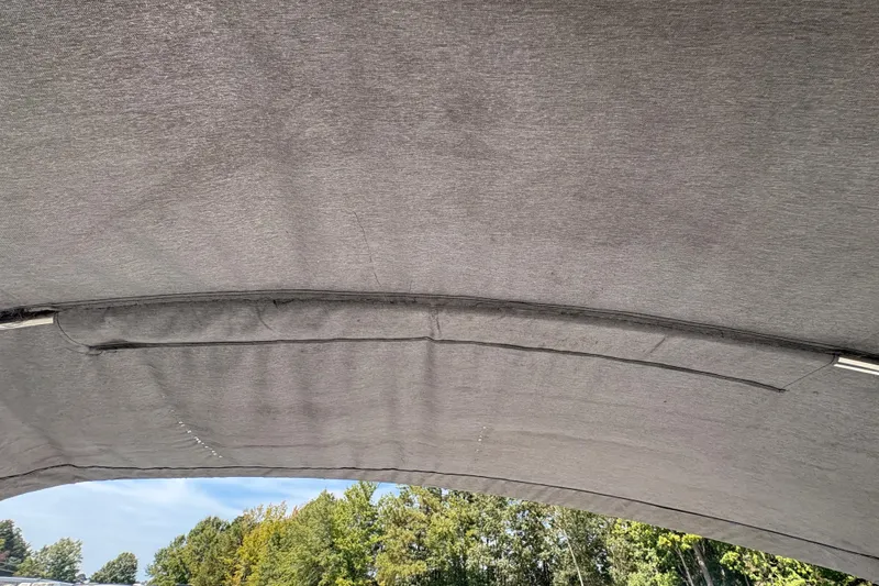 Slide: The Image of 2018 Yamaha SX210 boat canopy with trees in the background. - 26