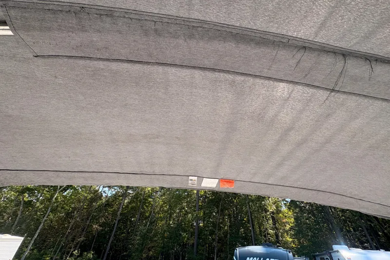 Slide: The Image of 2018 Yamaha Boats SX210 canopy with forest background. - 28