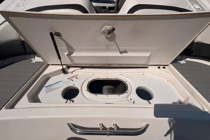 Slide: The Image of 2018 Yamaha Boats SX210 open storage compartment with seating area. - 7