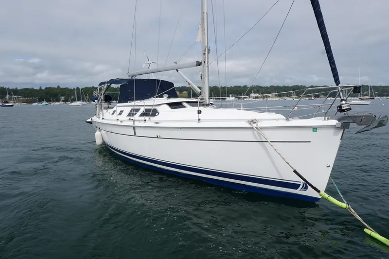 The Image of 2006 Hunter 41 Deck Salon sailboat anchored in a scenic harbor. - 0