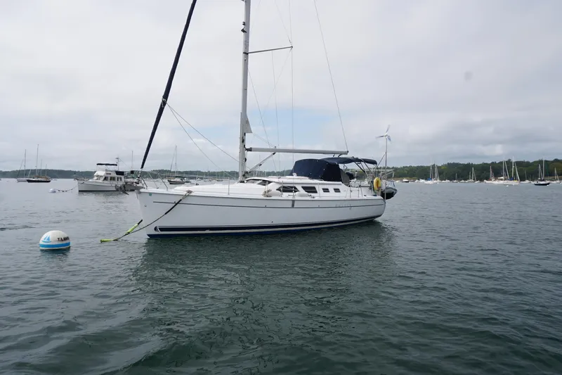 Slide: The Image of 2006 Hunter 41 Deck Salon sailboat anchored in a calm harbor. - 13