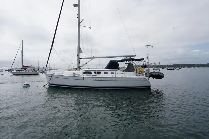 Slide: The Image of 2006 Hunter 41 Deck Salon sailboat anchored in a calm harbor. - 15