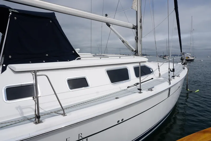 Slide: The Image of 2006 Hunter 41 Deck Salon sailboat on calm water, showcasing sleek design and modern features. - 2