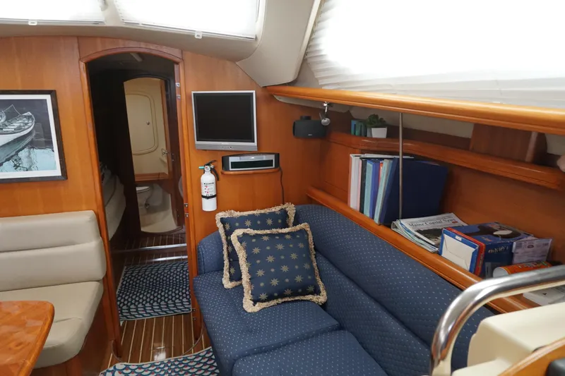 Slide: The Image of Interior of 2006 Hunter 41 Deck Salon with cozy seating and nautical decor. - 4