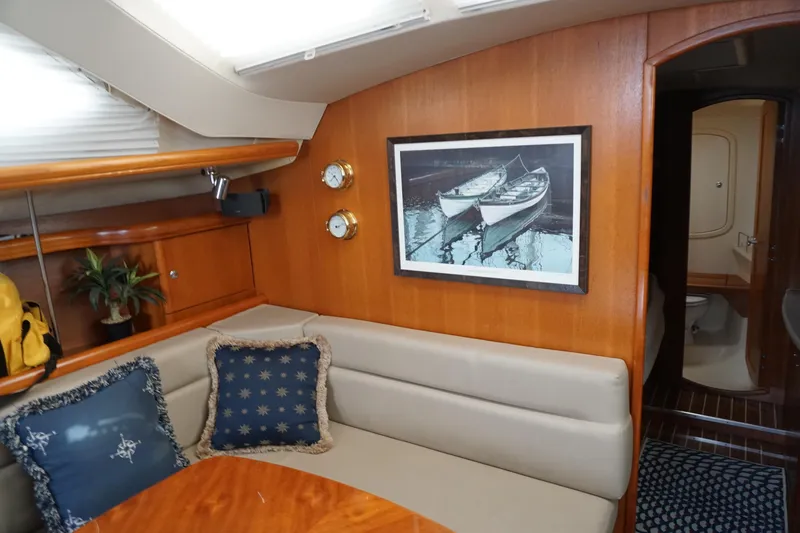 Slide: The Image of Interior of 2006 Hunter 41 Deck Salon with cozy seating and nautical decor. - 5