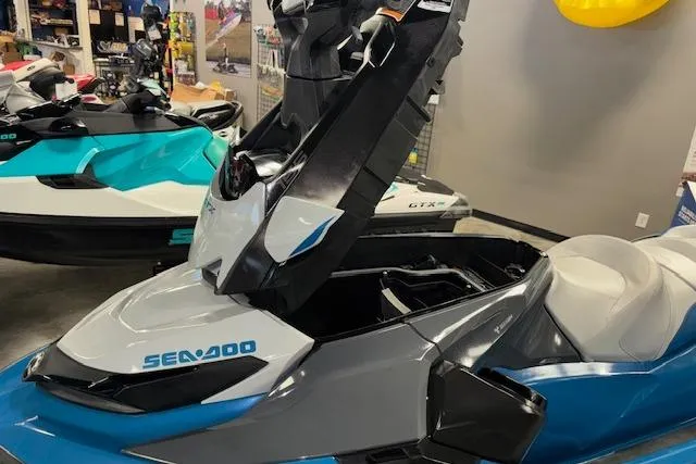 Slide: The Image of 2018 Sea-Doo GTX 155 jet ski with open storage compartment in showroom. - 15