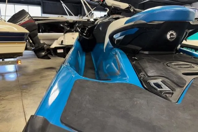 Slide: The Image of 2018 Sea-Doo GTX 155 jet ski in a showroom, featuring a sleek blue design. - 6