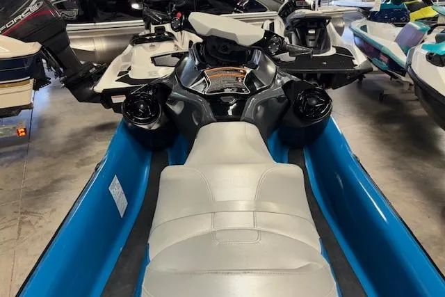 Slide: The Image of 2018 Sea-Doo GTX 155 jet ski with blue and white seating in showroom. - 8