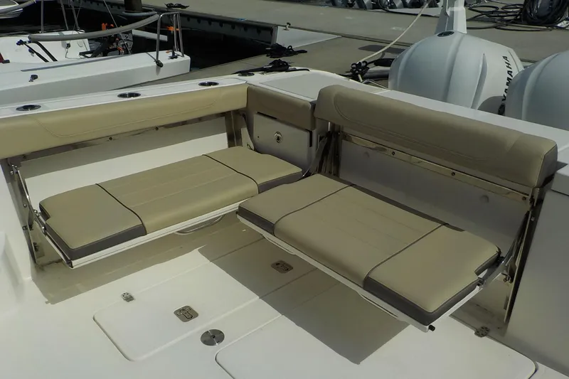 Slide: The Image of 2020 Pursuit OS 355 Offshore boat with beige foldable seating in the cockpit area. - 13