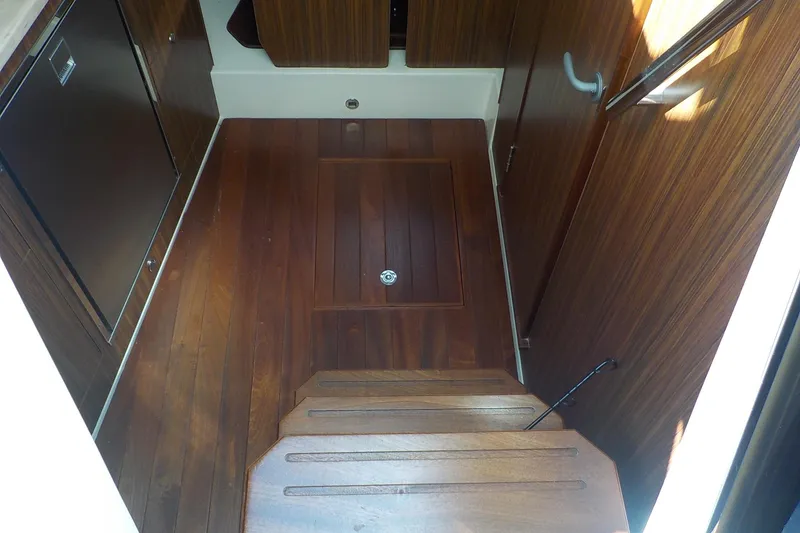 Slide: The Image of 2020 Pursuit OS 355 Offshore interior with wooden flooring and cabinetry. - 17