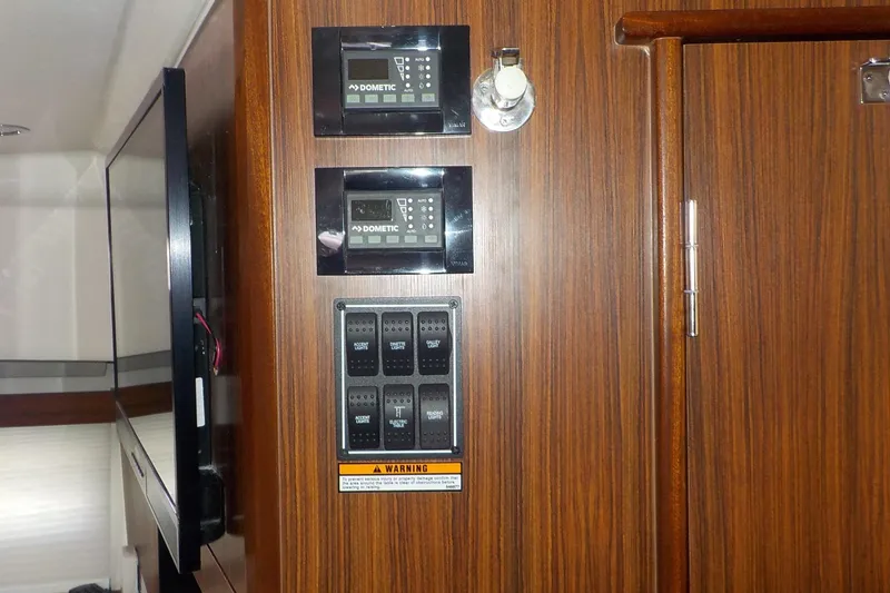 Slide: The Image of Control panel on 2020 Pursuit OS 355 Offshore boat with wood finish interior. - 27