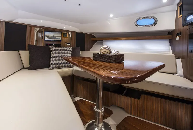 Slide: The Image of Manufacturer Provided Image: Interior of 2020 Pursuit OS 355 Offshore boat with elegant seating and wooden table. - 31
