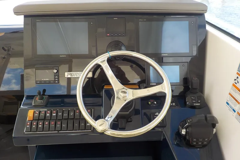 Slide: The Image of 2020 Pursuit OS 355 Offshore helm with Garmin displays and Yamaha controls. - 4