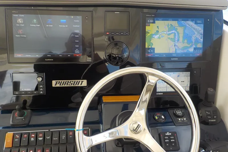 Slide: The Image of Control panel of a 2020 Pursuit OS 355 Offshore boat with Garmin navigation displays. - 8