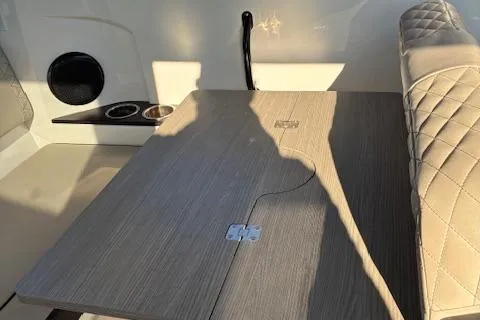 Slide: The Image of Interior of 2025 Navan C30 with wood table and quilted seating. - 15